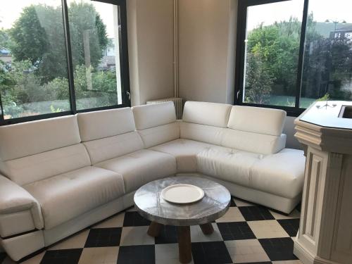 a living room with a white couch and a table at VILLA 87 - AY CHAMPAGNE in Ay