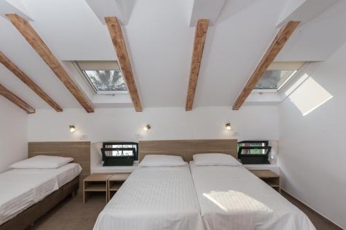 En eller flere senge i et værelse på Hotel Vimbula - Komolac