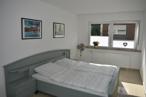 a bed sitting in a bedroom with a window at My Home - Ferienwohnung in Lüdinghausen
