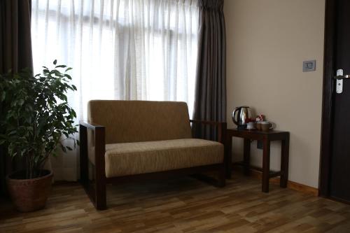 a chair sitting in a room with a window at Sabila Boutique Hotel in Kathmandu