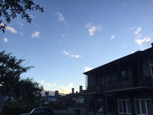 a building on a street with a blue sky at Teona's Guesthouse in Mestia in Mestia