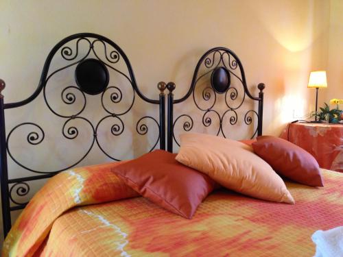 a bed with two pillows on top of it at El Pendola in Fumane