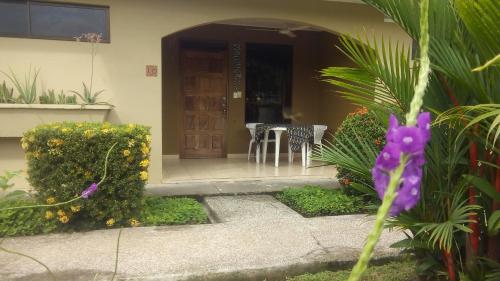 a front door of a house with a table and chairs at Villa Creole in Jacó