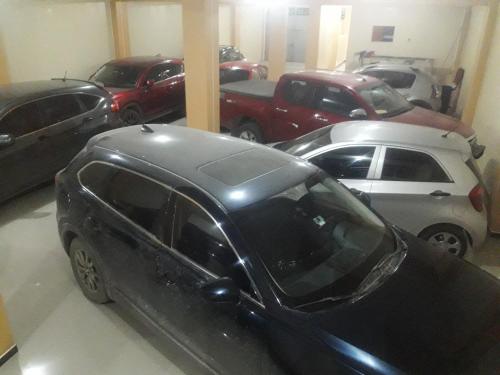 a black car parked in a garage with other cars at Gran Hotel Virrey in San Ramón