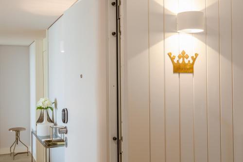 uma coroa pendurada numa parede num quarto em Almaria - Da Corte Apartments | Chiado em Lisboa