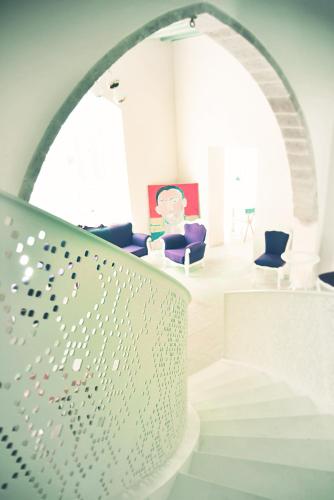 a white room with an archway and a staircase at Lokàl Boutique Hotel in Larnaka