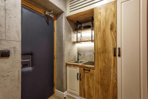 a small kitchen with a sink and a door at One Luxury Suites in Belgrade