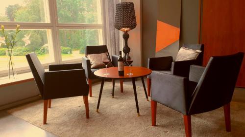 a dining room with a table and chairs and a window at Hotel Jollas89 in Helsinki