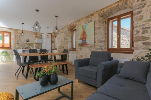 a living room with a couch and a table at Vila Magdalena in Supetar