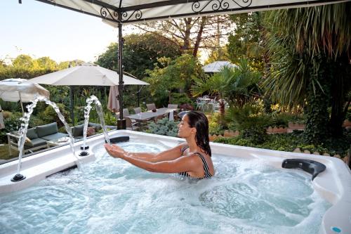 a woman is in a jacuzzi in a pool at La Villa Des Sens in Lattes