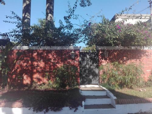 a brick wall with stairs in front of a fence at Granados in Asuncion