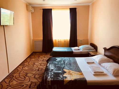 a hotel room with two beds and a window at Metropol in Rostov on Don