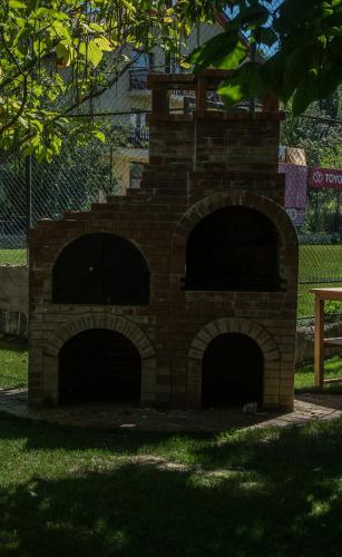 a brick oven with two openings in the grass at Enpi Lake Resort in Iaşi