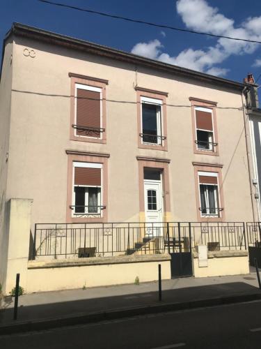 a white building with balconies on a street at Chambres Privées Ysy in Nancy