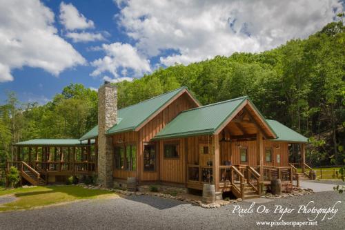 a log cabin with a green roof at Chetola Resort at Blowing Rock (Lodge) in Blowing Rock