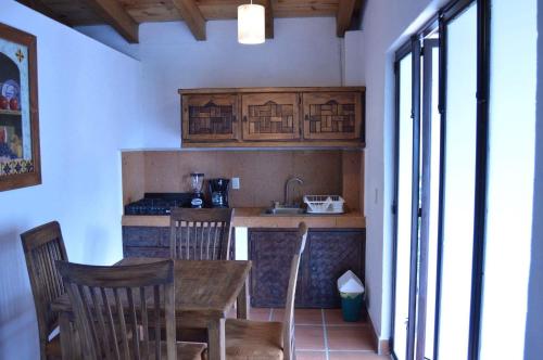 a kitchen with a wooden table and chairs in a room at Betos Departamentos in Valle de Bravo