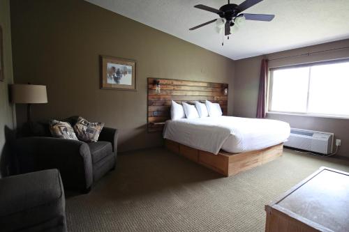 a bedroom with a bed and a chair and a window at Hidden Canyon Retreat in Baker