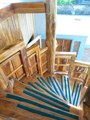 an overhead view of a wooden room with a tree at Teak villa in Thoeng