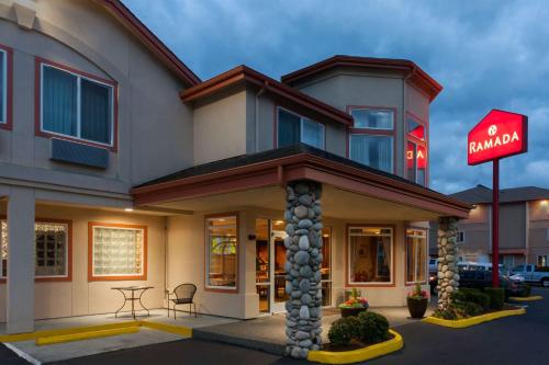 a building with a sign in front of it at Ramada by Wyndham SeaTac Airport North in Tukwila