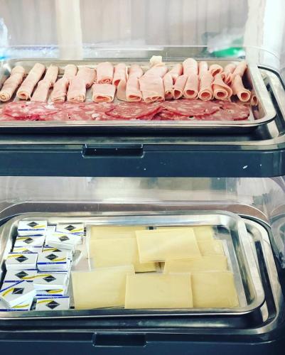 two trays of hot dogs and cheese in an oven at Zia Bi Bed and Breakfast in Naples
