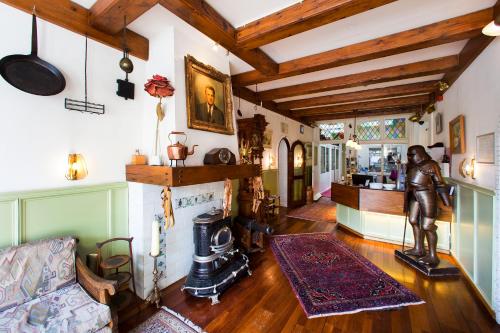 a living room with a couch and a fireplace at Amsterdam Wiechmann Hotel in Amsterdam