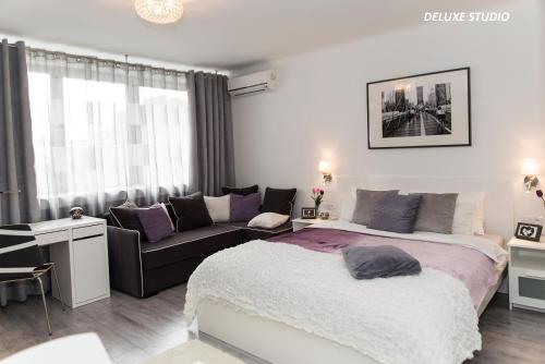 a large white bed in a room with a large window at Warsawrent Apartamenty Centralna in Warsaw