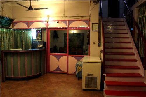 a room with a staircase leading to a room with a bar at Sahi River View Guest house in Varanasi