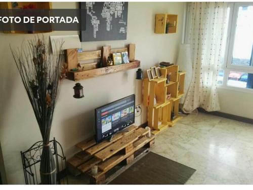 a living room with a flat screen tv on a wall at Papá Totë in Playa Honda