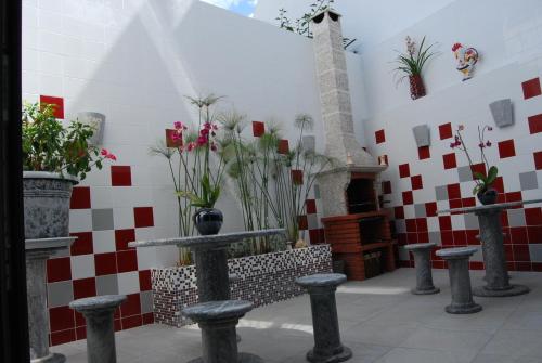 a room with red and white tiles on a wall with potted plants at The Birds Nest in Alvor