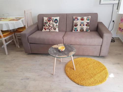 uma sala de estar com um sofá e uma mesa em Studio em Tivat