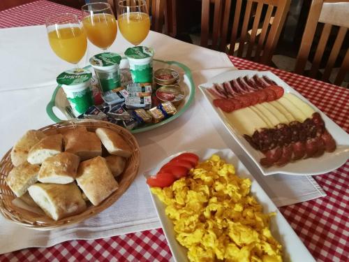 a table topped with plates of breakfast foods and drinks at Pansion Rody in Gornja Stubica