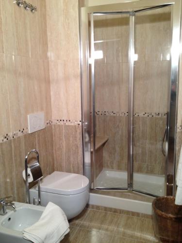 a bathroom with a shower and a toilet and a sink at La Dependance in Menaggio