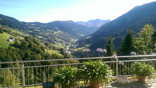 a balcony with a view of a valley with mountains at Appartement Mangeng in Bartholomäberg