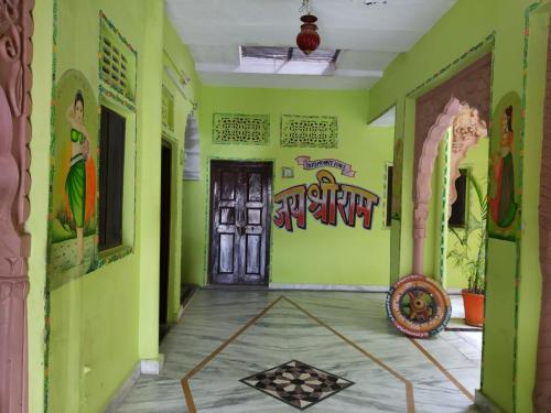 a room with green walls and a door with graffiti at Hotel Paramount Palace in Pushkar