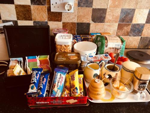 a counter top with a tray of food and snacks at Treasure Box Retreat in Clifden