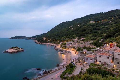 an aerial view of a town on the shore of a body of water at Yo Ho 23 Homestay in Beigan