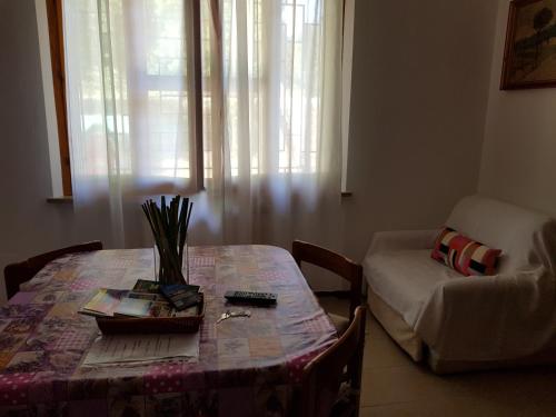 a living room with a table and a couch at Relax da Sabry in Senigallia