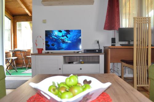 a living room with a bowl of fruit on a table at Apartment Enjoy in Kolašin