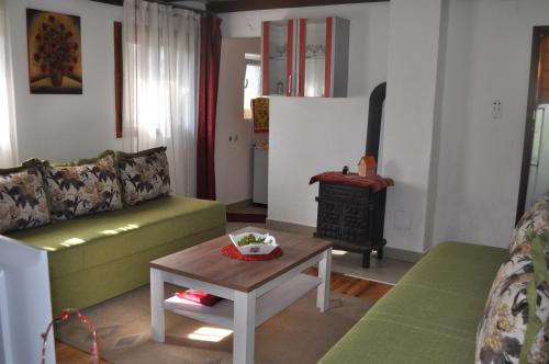 a living room with a couch and a stove at Apartment Enjoy in Kolašin