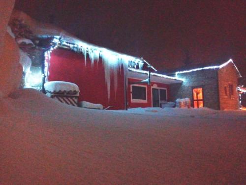 a house covered in snow with lights on it at Aia di Lazzaro Agriturismo in Casalbore