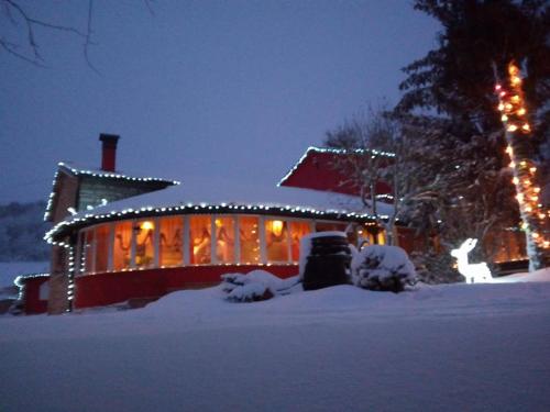 a house covered in snow with christmas lights at Aia di Lazzaro Agriturismo in Casalbore