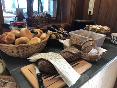 a counter with baskets of bread and other items on it at Hotel Seiserhof & Seiseralm in Bernau am Chiemsee