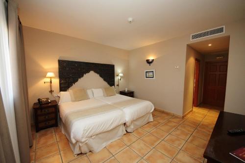 Ένα ή περισσότερα κρεβάτια σε δωμάτιο στο Hotel Château Viñasoro