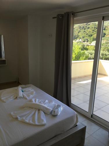a bedroom with a bed with white towels on it at Villa Martini in Kissamos