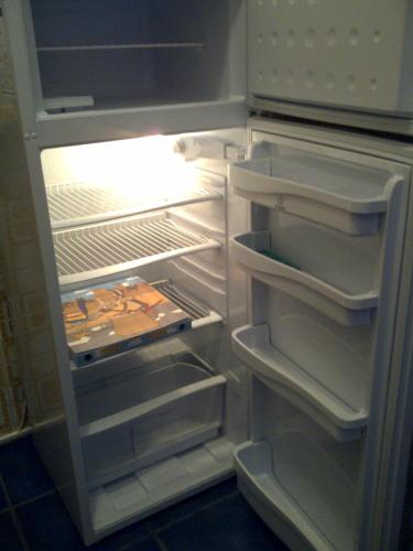 an open refrigerator with its door open and its doorsearchacersacersacersacersngth at Adriella apartments in Bibione