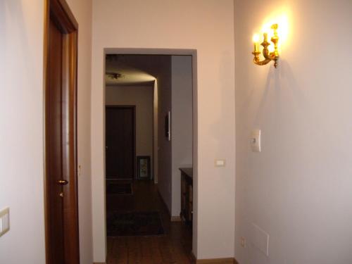 a hallway with a door and a light on a wall at Agriturismo Il Borgo Degli Ulivi in Roseto degli Abruzzi