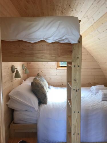 a bedroom with a bunk bed in a cabin at Sutor Coops The Nest with Hot Tub in Cromarty