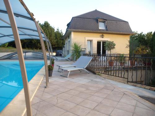 patio con sedia bianca accanto alla piscina di Chambres d'Hôtes Entre Deux Rives a Honfleur