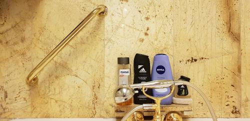 a bathroom counter with a sink with products on it at Comfy & Cosy Apartment in Katowice