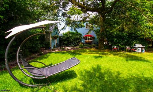 a metal swing in the yard of a house at Herlihy's, Half-Way-House in Farranfore